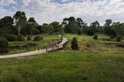 Scenic view of grassy field against cloudy sky