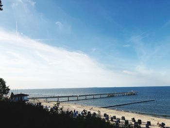 People on beach against sky