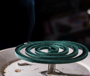 Close-up of spiral metal on table