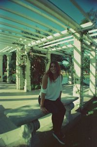 Portrait of a smiling young woman sitting outdoors