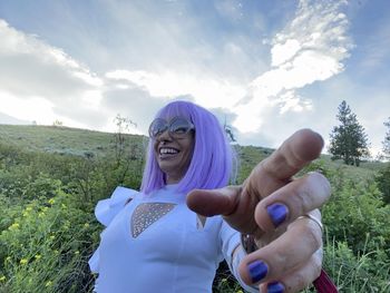 Low angle view of young woman at festival candid laughing