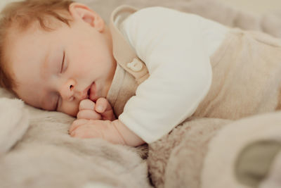 Cute baby sleeping on bed