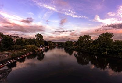 Scenic view of river against sky at sunset