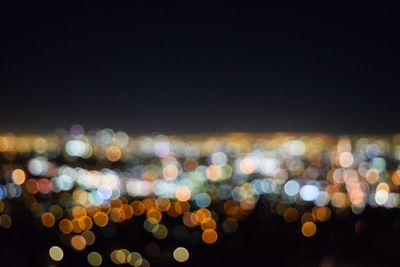 Defocused image of illuminated city at night