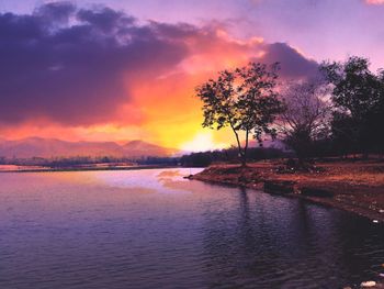 Scenic view of lake against sky during sunset