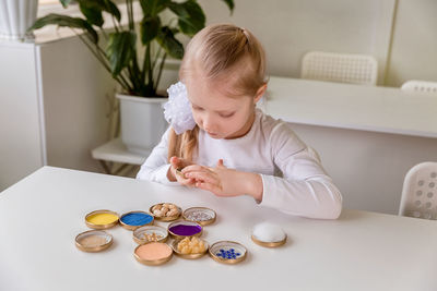 Cute baby girl sitting on table