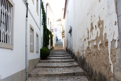 Alley amidst buildings against sky