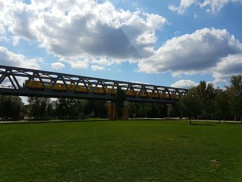 Bridge over field against sky