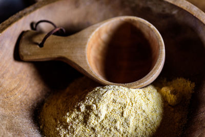 Close-up of cornmeal in wooden container