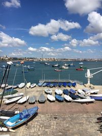 Sailboats moored in harbor