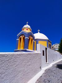 Low angle view of building against clear blue sky