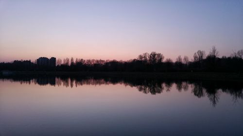 Scenic view of calm lake at sunset