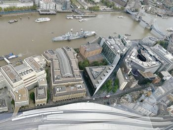 High angle view of road by river and buildings in city