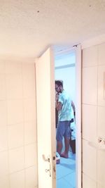 Woman standing by door at home