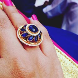 Close-up of woman hand holding purple butterfly