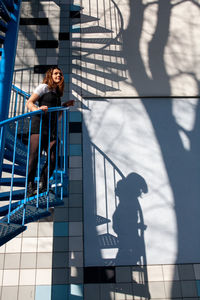 Shadow of woman on railing