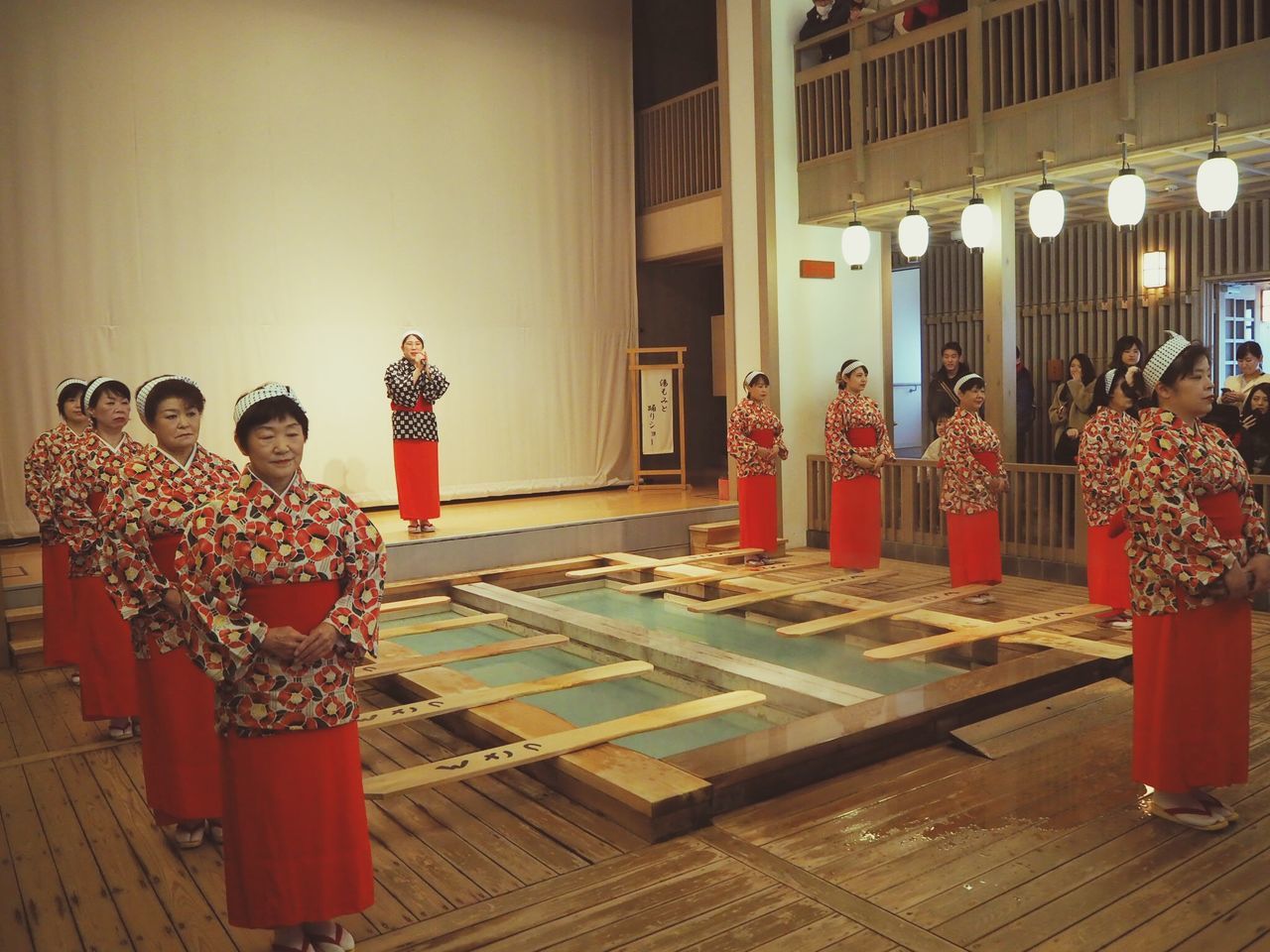 group of people, women, traditional clothing, real people, adult, indoors, rear view, men, togetherness, architecture, clothing, people, built structure, flooring, lifestyles, standing, group, religion, architectural column