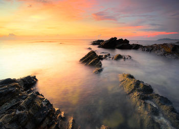 Scenic view of sea against sky at sunset