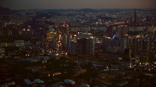 High angle view of illuminated city buildings at night