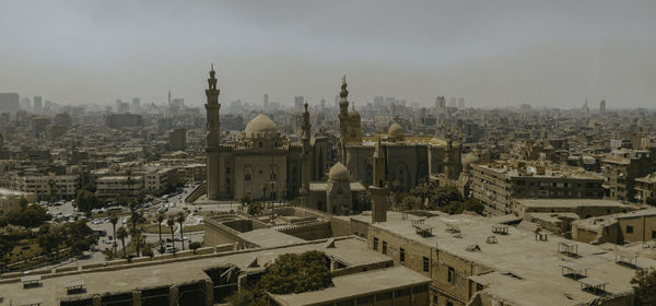Cairo cityscape against clear sky during afternoon with mosque in center 