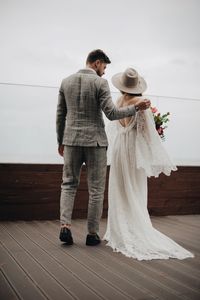 Bride and bridegroom on boardwalk