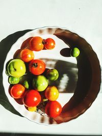 High angle view of tomatoes in plate on table