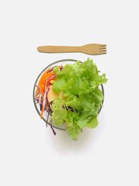 Directly above shot of salad in plate against white background