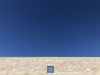 Low angle view of building against blue sky