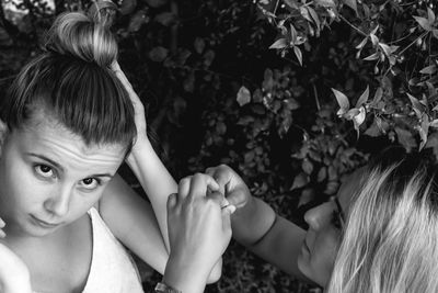 Close-up of sisters against plants