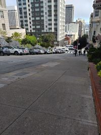 Road by buildings in city