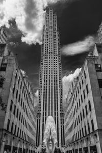 Low angle view of statue against buildings in city