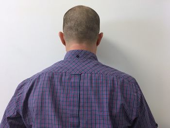 Rear view of man against white background