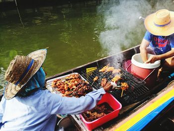 High angle view of woman with hat in water