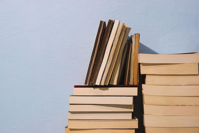 Stack of books on table against wall