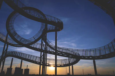 Low angle view of silhouette steps against sky during sunset