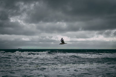 Scenic view of sea against cloudy sky