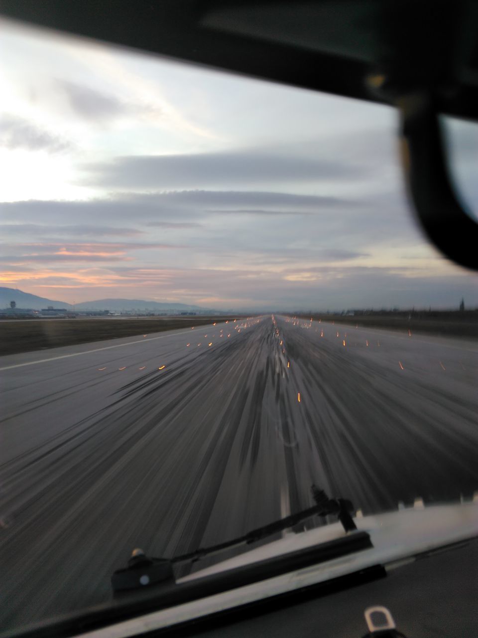 ROAD SEEN THROUGH WINDSHIELD OF CAR