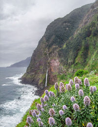 Scenic view of sea and mountains against sky