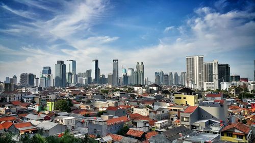 Buildings against cloudy sky