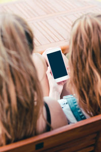 Midsection of woman using mobile phone