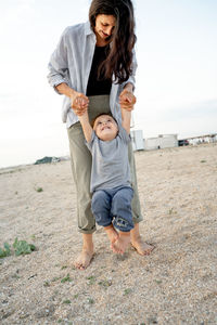 Portrait of young woman standing at beach