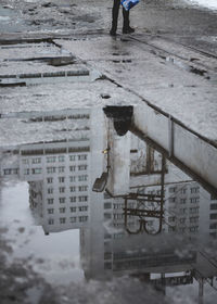 Reflection of building in puddle