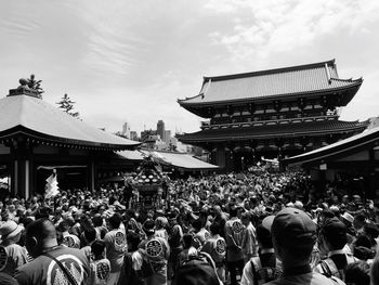 Crowd standing outside temple in japan