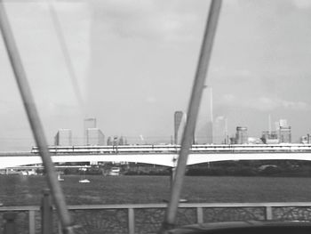 View of suspension bridge with city in background