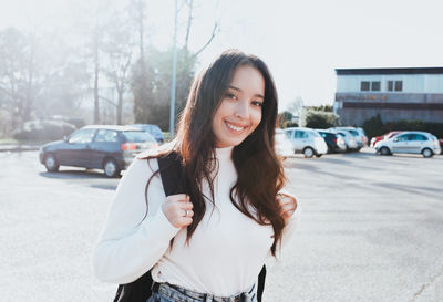 Portrait of smiling young woman standing outdoors