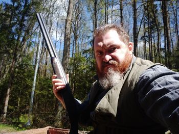 Portrait of senior man standing in forest