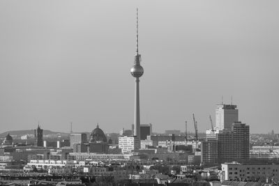 Buildings in city against clear sky