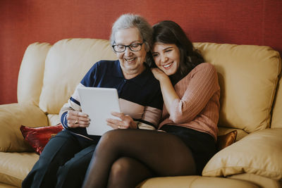 Granddaughter and grandmother watching something on the tablet