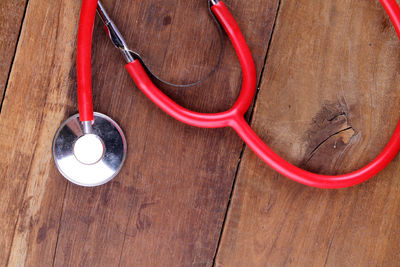 Directly above shot of red stethoscope on table