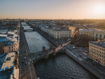 Aerial sunset cityscape of fontanka river in saint petersburg, russia. lomonosov bridge across river